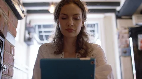 Attractive young female using a digital tablet in a coffee shop Stock-Footage 92859471