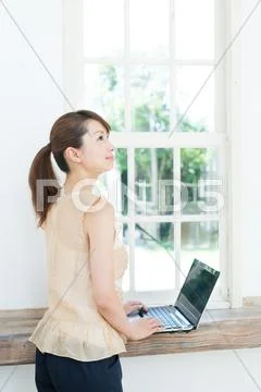 Attractive young girl working with laptop Stock Photos