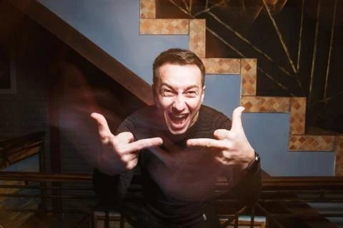 Attractive young guy looking at camera and showing fuck off... Foto stock