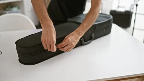 Attractive young hispanic man, a classical musician, concentrating as he op.. Stock Footage 258027162