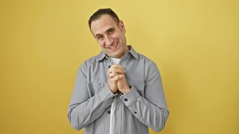 Attractive young hispnica man wearing a shirt, standing in devout prayer wi.. Stock Footage 268570357