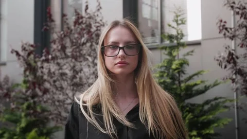 Attractive young lady is walkingtoward camera, looks into camera and mesmerizing Stock Footage 242780063