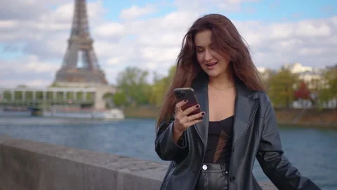An attractive young lady wearing using a phone in Paris town. Medium shot Stock Footage 218851305