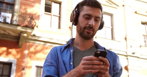 Attractive Young Man Communicated on Mobile Social Network, listening Music.  Stock Footage 99234757