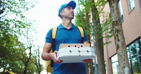 Attractive young man courier with backpack delivering order in business district Stock Footage 140113621