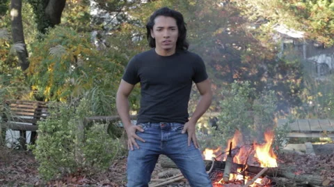 Attractive Young Man Dancing by Fire Stock Footage 57990937