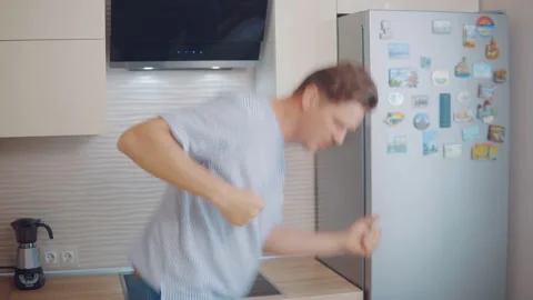 Attractive young man is dancing in the kitchen. Stock Footage 133323418