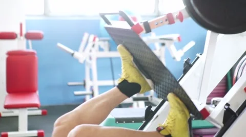 Attractive Young Man Doing Leg Press On Machine In Gym Stock Footage 62445925