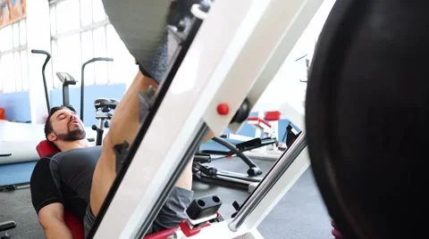 Attractive Young Man Doing Leg Press On Machine In Gym Stock-Footage 62446146