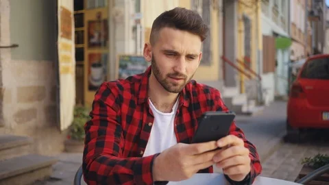 Attractive young man doing selfie uses phone sitting in cafe smile feel happy Video stock 92071270