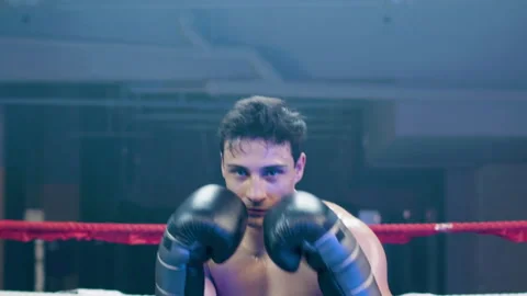 Attractive young man doing shadow fight towards camera Stock-Footage 181845360