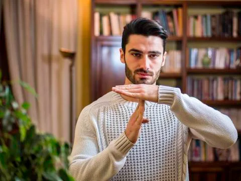 Attractive young man doing time-out sign Stock Photos
