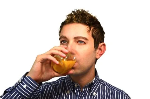 Attractive young man drinking fruit juice Stock Photos