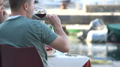 Attractive young man drinking red wine by the glass Vidéo 96248537