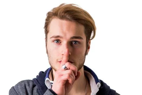 Attractive young man gesturing Hush or Silence Stock Photos