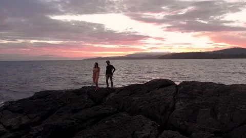 A attractive young man getting on his knee to propose to his girlfriend beside Stock Footage 132368228