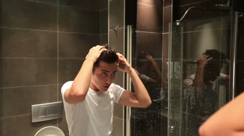 Attractive young man looking mirror Видео 25420459