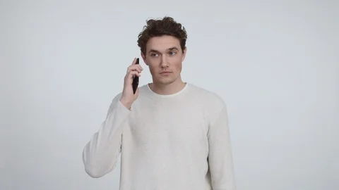 Attractive Young Man Looking Troubled After Receiving a Phone Call Stock Footage 116651523