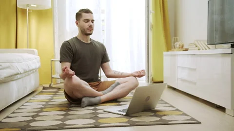 An attractive young man is making healthy exercises on the Internet Stock Footage 156001196