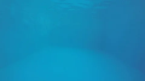 Attractive young man playing in a pool in summer 動画素材 106309928