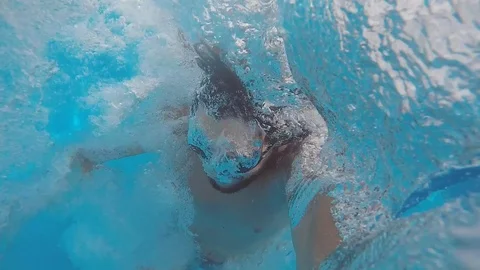 Attractive young man playing in a pool in summer 動画素材 106310154