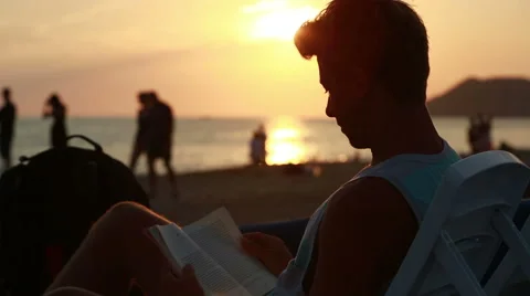 Attractive young man reading a book Stock Footage 41336652