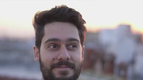 Attractive Young Man Smiling,  On Rooftop of a building at Sunse Timet,  Slow Stock Footage 106724393