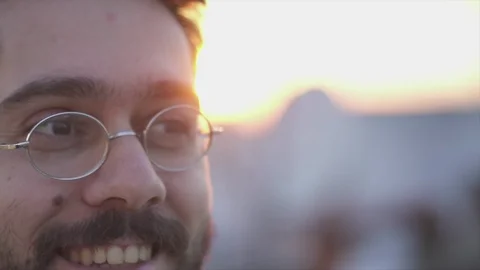 Attractive Young Man Smiling,  On Rooftop of a building at Sunse Timet,  Slow Vídeos de archivo 106724410