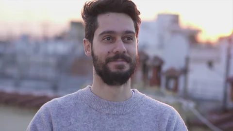 Attractive Young Man Smiling,  On Rooftop of a building at Sunse Timet,  Slow Stock Footage 106724420