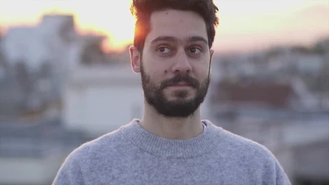 Attractive Young Man Smiling  On Rooftop of a building at Sunset Time,  Slow  Видео 106724454