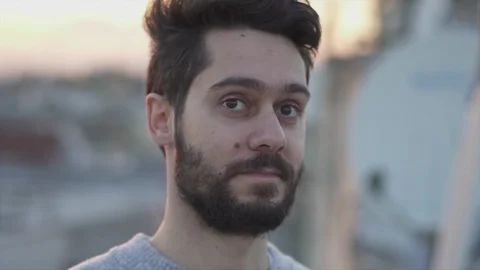 Attractive Young Man Smiling  On Rooftop of a building at Sunset Time,  Slow  Stock Footage 106724466