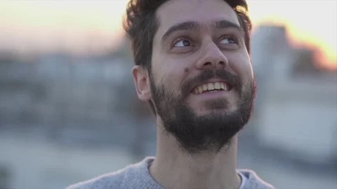 Attractive Young Man Smiling  On Rooftop of a building at Sunset Time,  Slow  Stock Footage 106724503