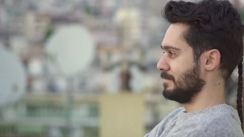 Attractive Young Man Smiling  On Rooftop of a building,Slow Motion Shot with  Stock Footage 106727762