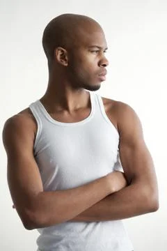 Attractive young man standing with arms crossed Stock Photos