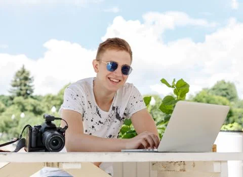 Attractive young man student using laptop outside Stock Photos