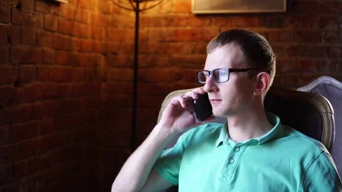 Attractive, young man talking on cellphone in cafe Video stock 73126898