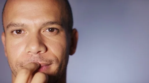 Attractive young man thinks about something before smiling to camera, with space Video stock 83329343