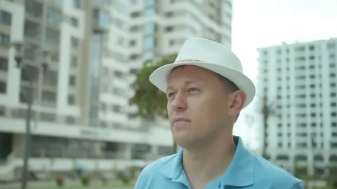 Attractive young man uses a mobile application on his phone, stands on a city Stock Footage 158697757