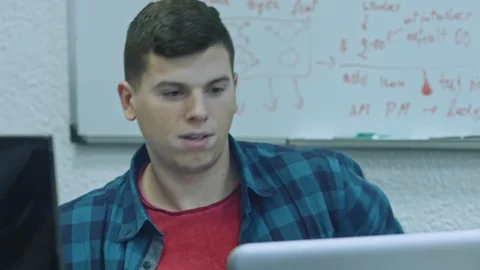 Attractive young man using computer at his working place. Office worker is Stock Footage 105808573
