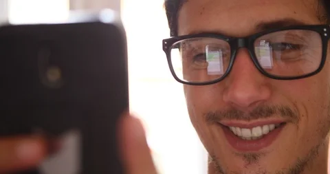 Attractive young man using smart phone reflection eye glasses hipster concept Stock Footage 91939890
