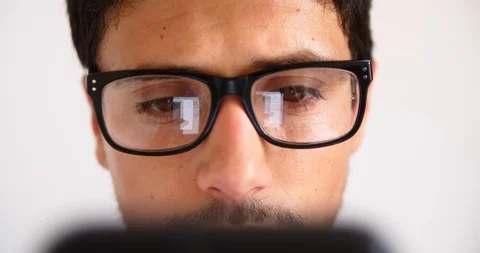 Attractive young man using smart phone reflection eye glasses hipster concept Stock Footage 91940672