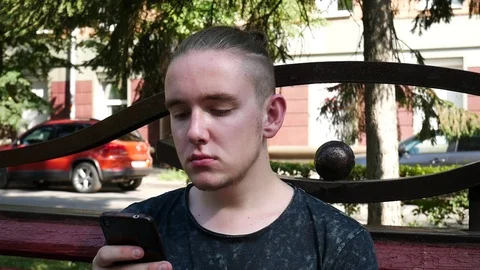 An Attractive Young Man Using Smartphone Stock Footage 114825307