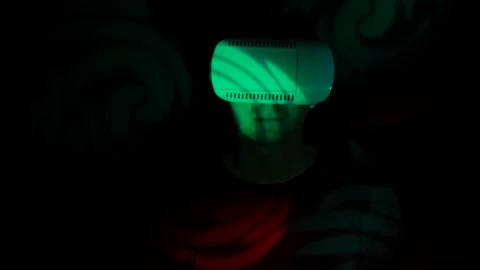Attractive young man in virtual reality glasses on a bright multicolored Stock Footage 86607688