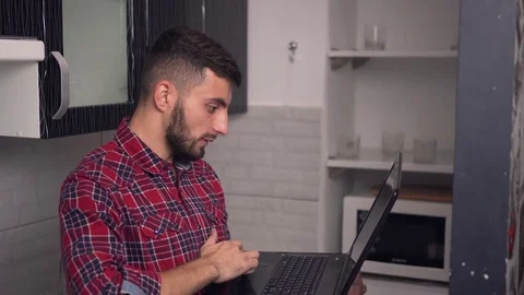 Attractive Young Man Work on Laptop in Kitchen 動画素材 70103286