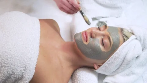 Attractive young model face mask spa skin care beautiful woman female brush Vídeos de archivo 76300043