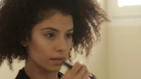 Attractive young model putting makeup Stock Footage 73320080