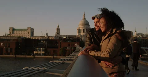 An attractive young multi-ethnic couple walking on a wooden bridge. Shot on RED  Stock Footage 56139734