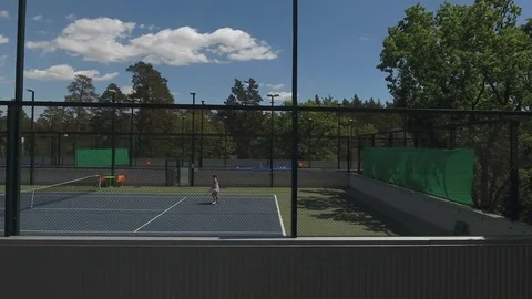 Attractive young people play tennis on the court Stock Footage