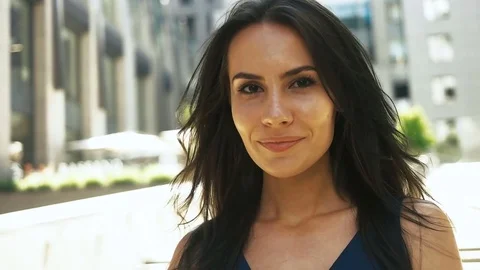 Attractive young smiling lady posing on professional camera near her office Stock Footage 73813529