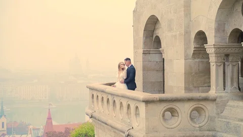 Attractive young wedding couple, bride in long blond dress with long blond hair  Stock Footage 129505957